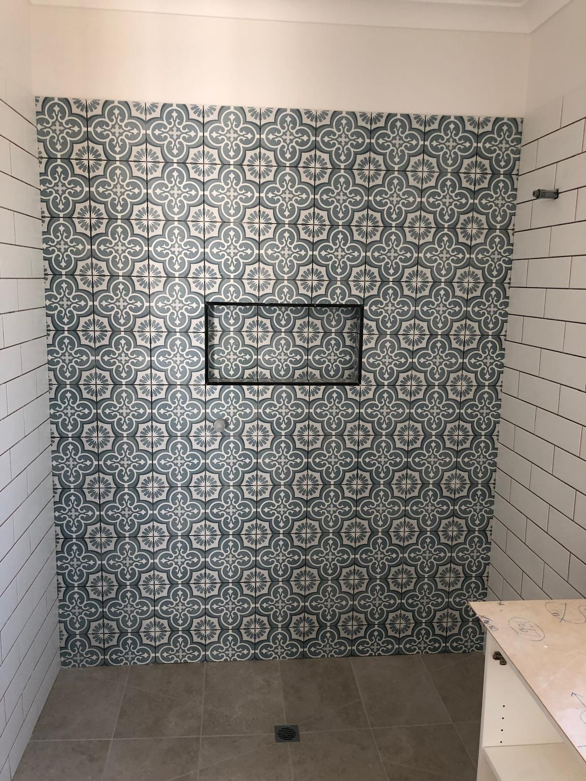 Bathroom shower with patterned tile wall — Clyde North