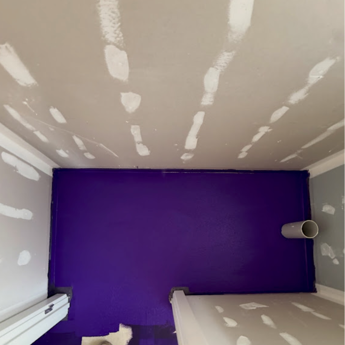 Purple waterproofing membrane applied to shower wall — Dandenong bathroom job by Casey Quality Coatings