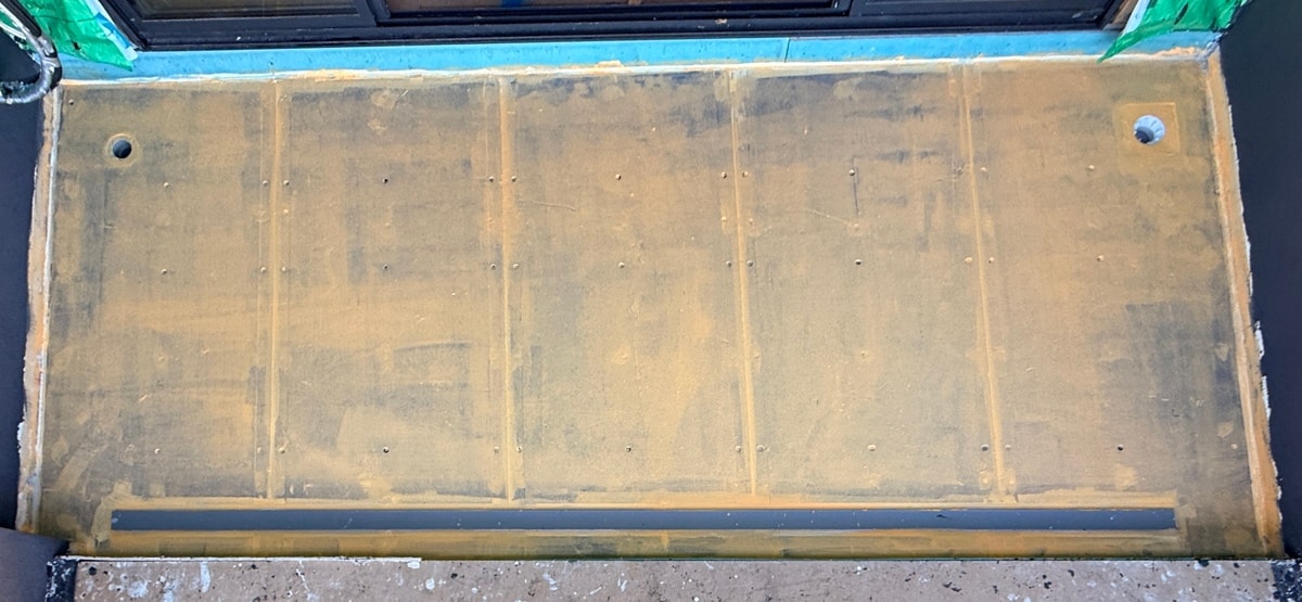Balcony fibre cement substrate screwed down with linear drain and pipe penetrations — Endeavour Hills by Casey Quality Coatings