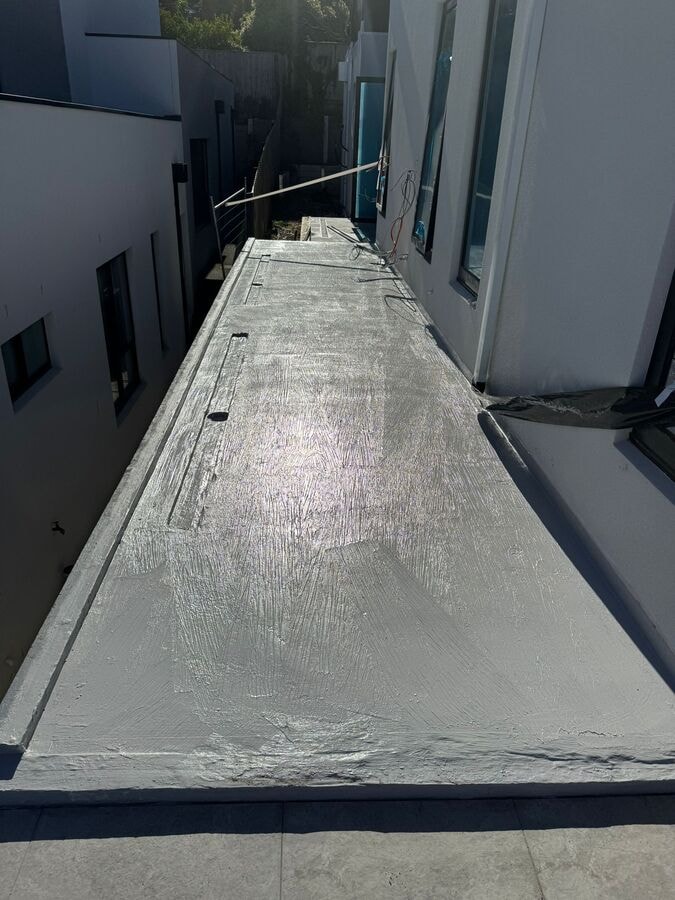 Grey waterproofing membrane applied edge to edge over balcony — Narre Warren South by Casey Quality Coatings